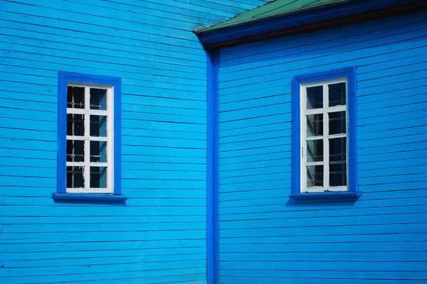 Окна на голубой стене — стоковое фото