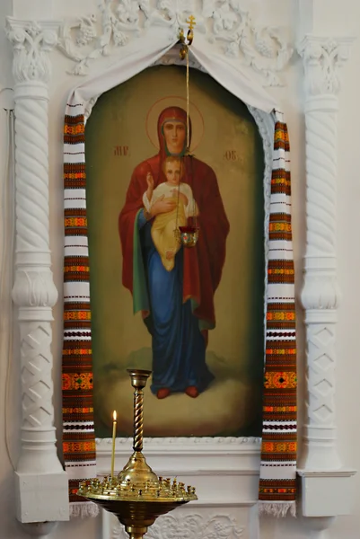 Portacandele con candela accesa nella chiesa sullo sfondo dell'icona — Foto Stock