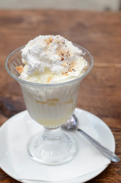 Vanilla ice cream with coconut, pineapple and whipped cream — Stock Photo, Image