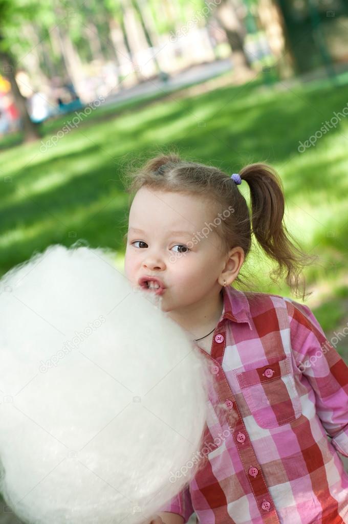 Girl eating cotton candy — Stock Photo © tarik_vision 28359273