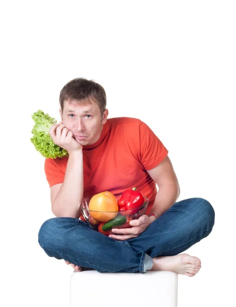 stock image Young man with plate of fresh healthy vegetables