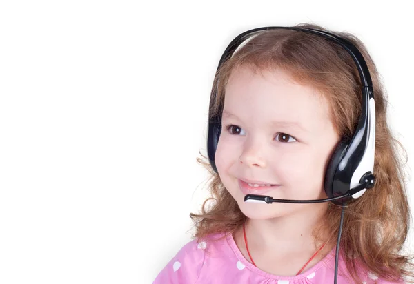 Lächelndes kleines Mädchen im Headset — Stockfoto