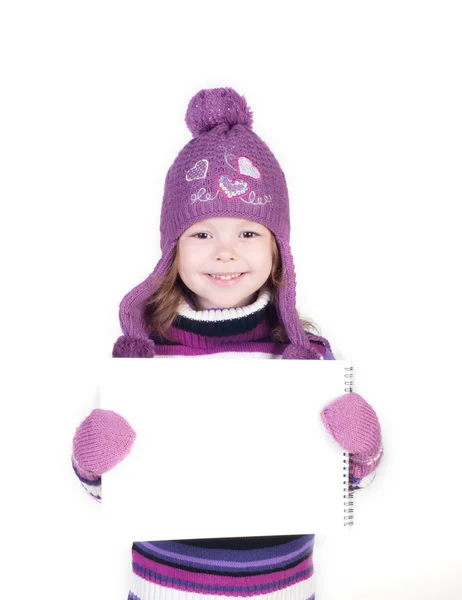 Cute little girl in warm clothes showing empty copy space — Stock Photo, Image