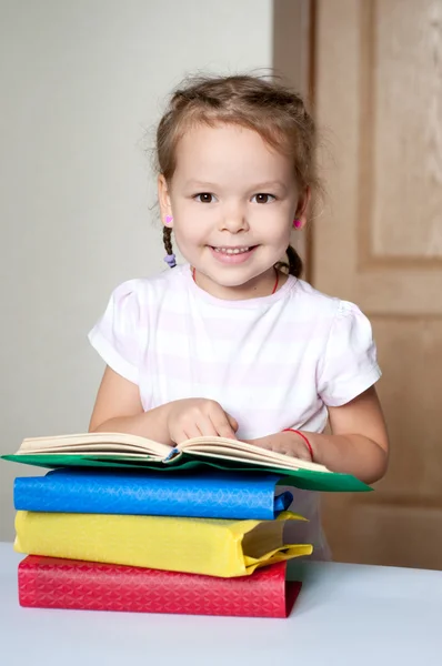 Cute cheerful little girl with books — Stock Photo, Image