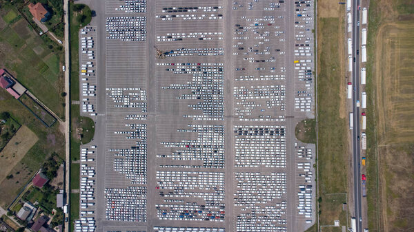 Empty parking lots, aerial view. A lot of cars in the parking lot. Colorful moody drone shoot