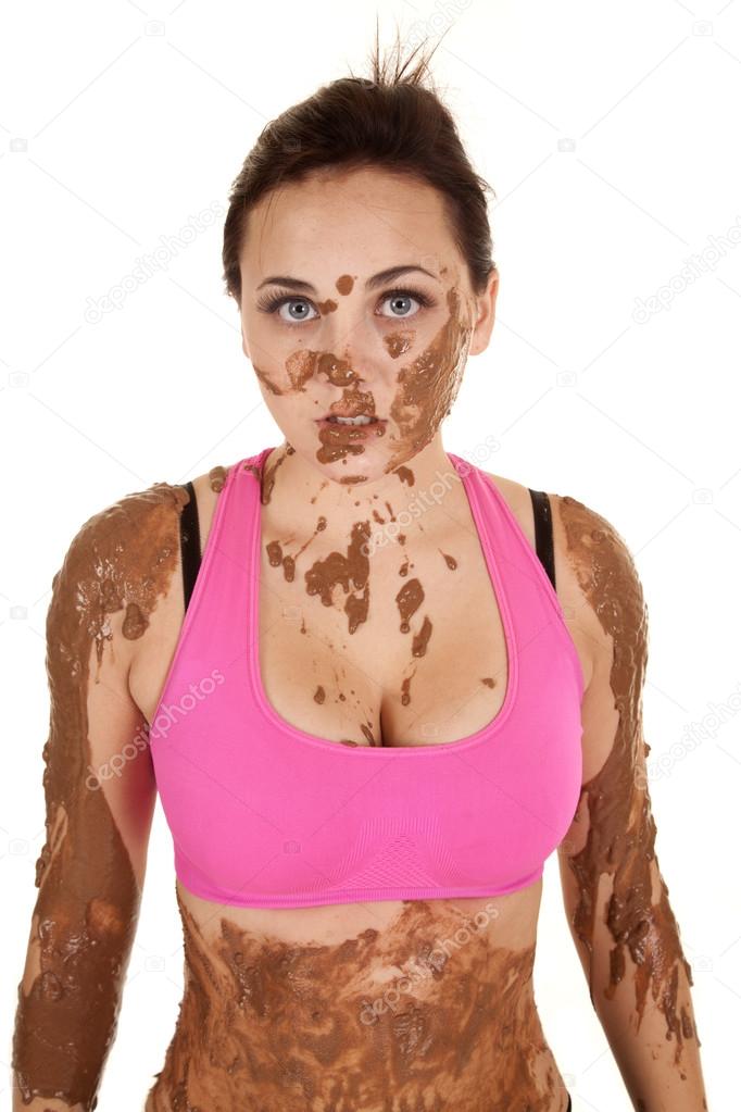 woman pink sports top mud stare