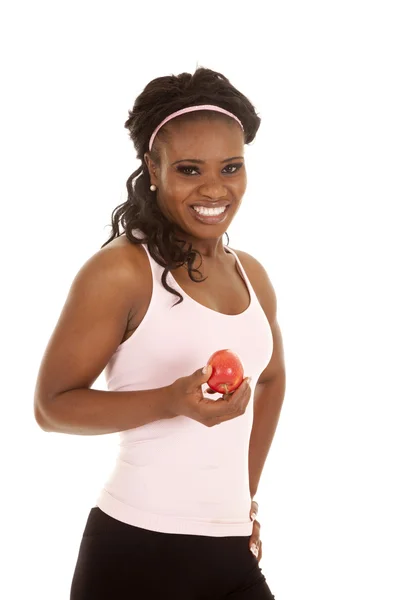 Жінка рожевий верх тримає яблуко — стокове фото