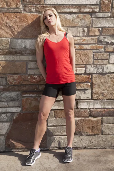 Woman red fitness stand by wall — Stock Photo, Image
