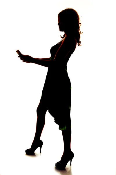 Silhouette of woman holding a phone — Stock Photo, Image