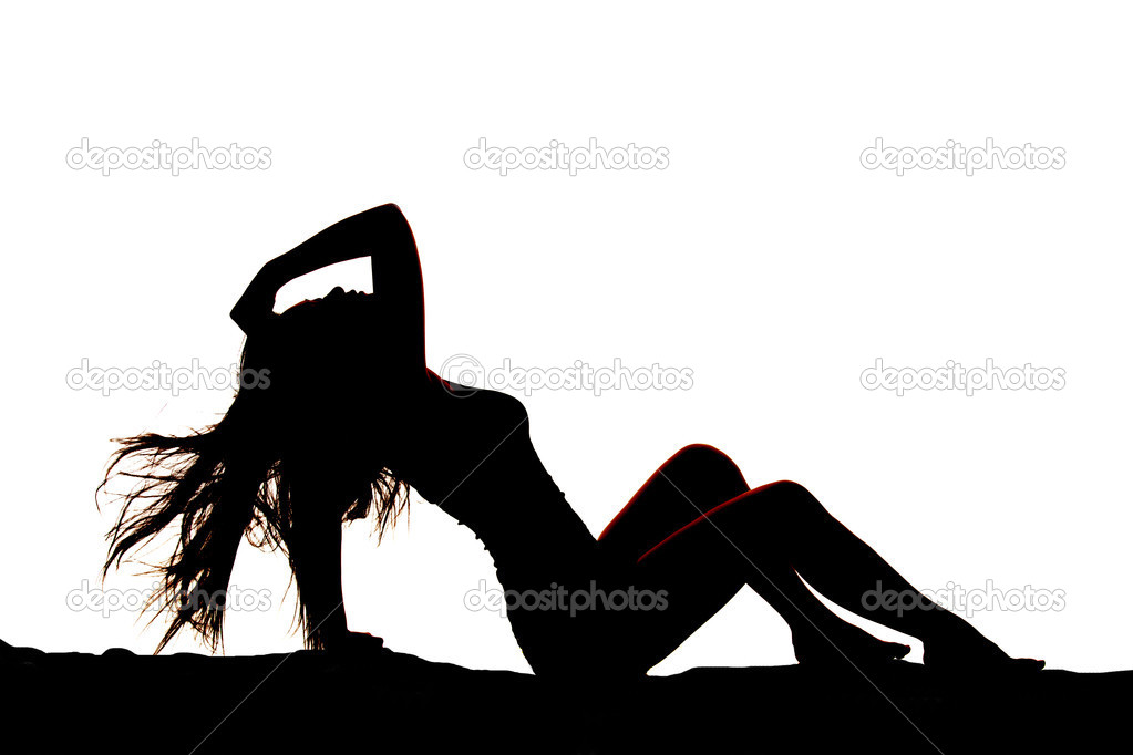 a silhouette of a woman leaning back with the wind blowing her hair photo by alanpoulson