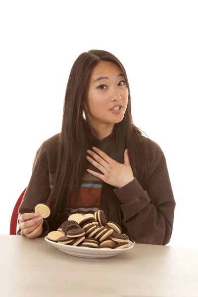 Woman plate of cookies one in hand — Stock Photo, Image