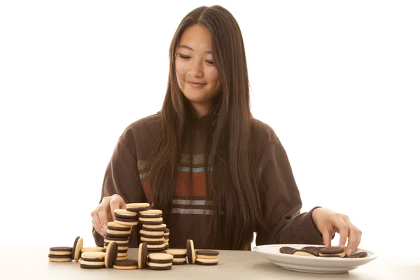 Woman stacking cookies smile — Stock Photo, Image