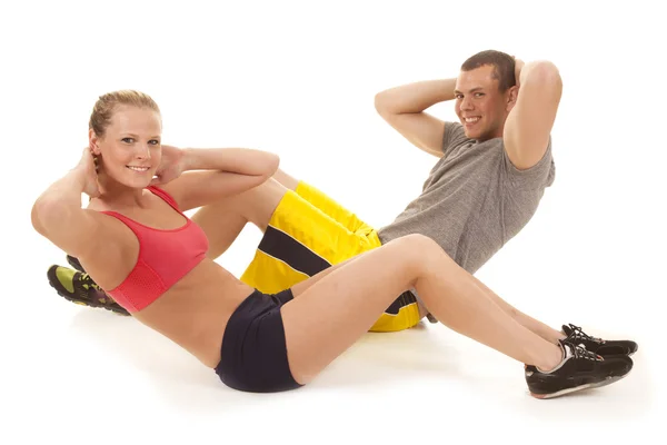 Couple fitness doing crunches — Stock Photo, Image