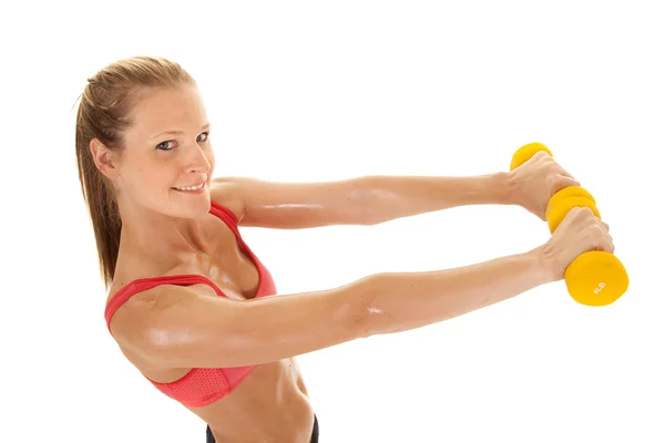 Fitness woman red sports bra hold both weights out — Stock Photo, Image
