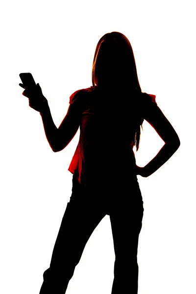 Silhouette of woman holding out cell phone. — Stock Photo, Image