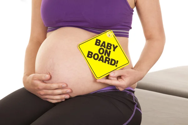 Baby na palubě držet břicho — Stock fotografie