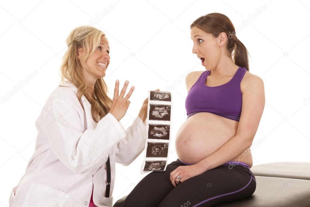 Doctor pregnant woman ultrasound triplets