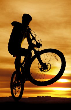 Bike silhouette popping up front tire clipart