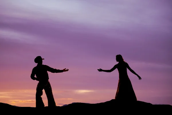 Cowboy reach for woman silhouette — Stock Photo, Image