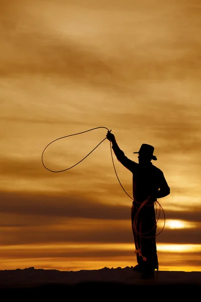 Cowboy silhouette swing rope — Stock Photo, Image