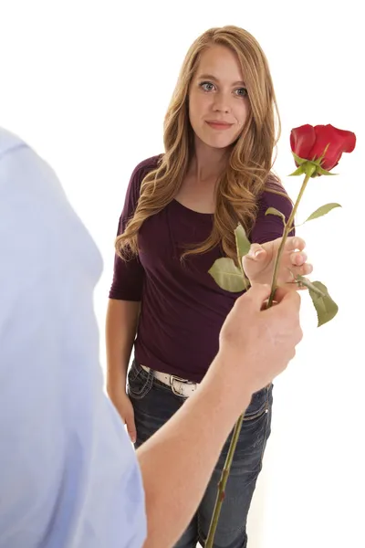 Girl reaching out to grab rose from guy — Stock Photo, Image