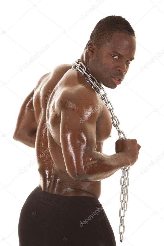 Strong man with chain back look around