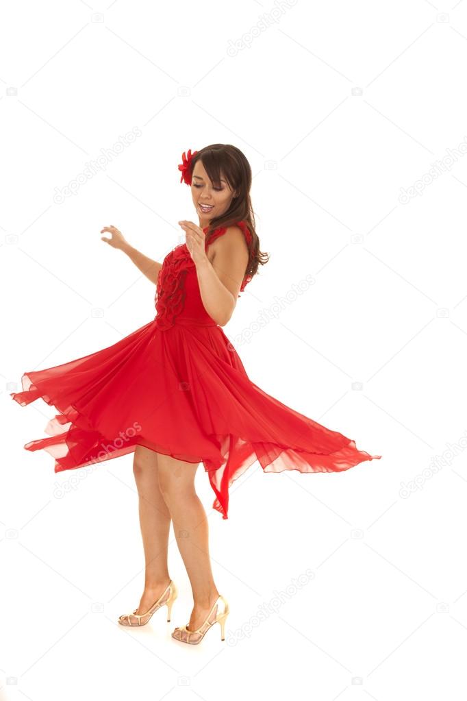 woman in a red dress spins and looks down