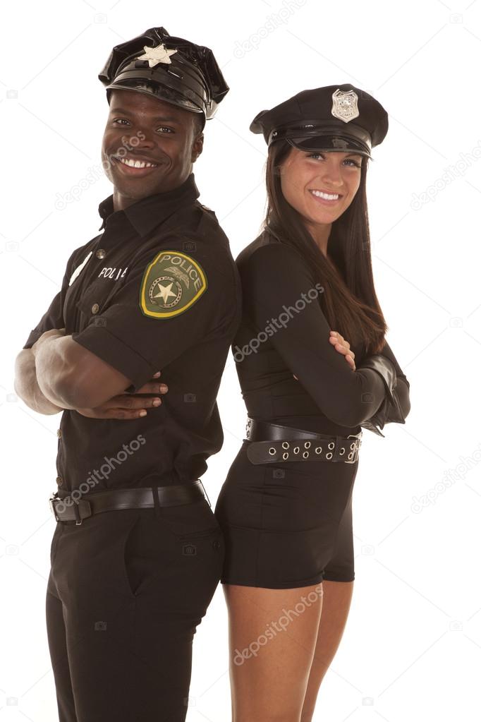 male and female cop back to back smiling