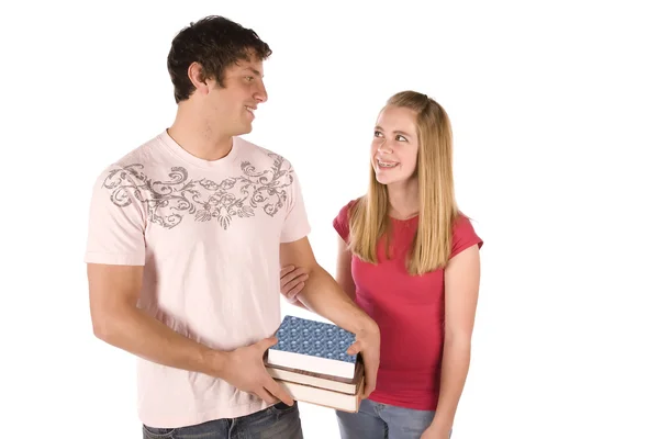 Teen boy holding books of girl — Stock Photo, Image