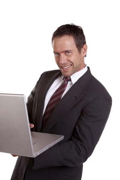 Homem com laptop e sorrindo — Fotografia de Stock