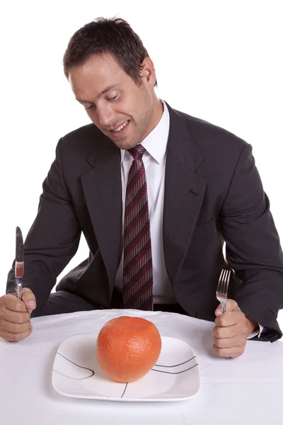 Man with orange on plate — Stock Photo, Image