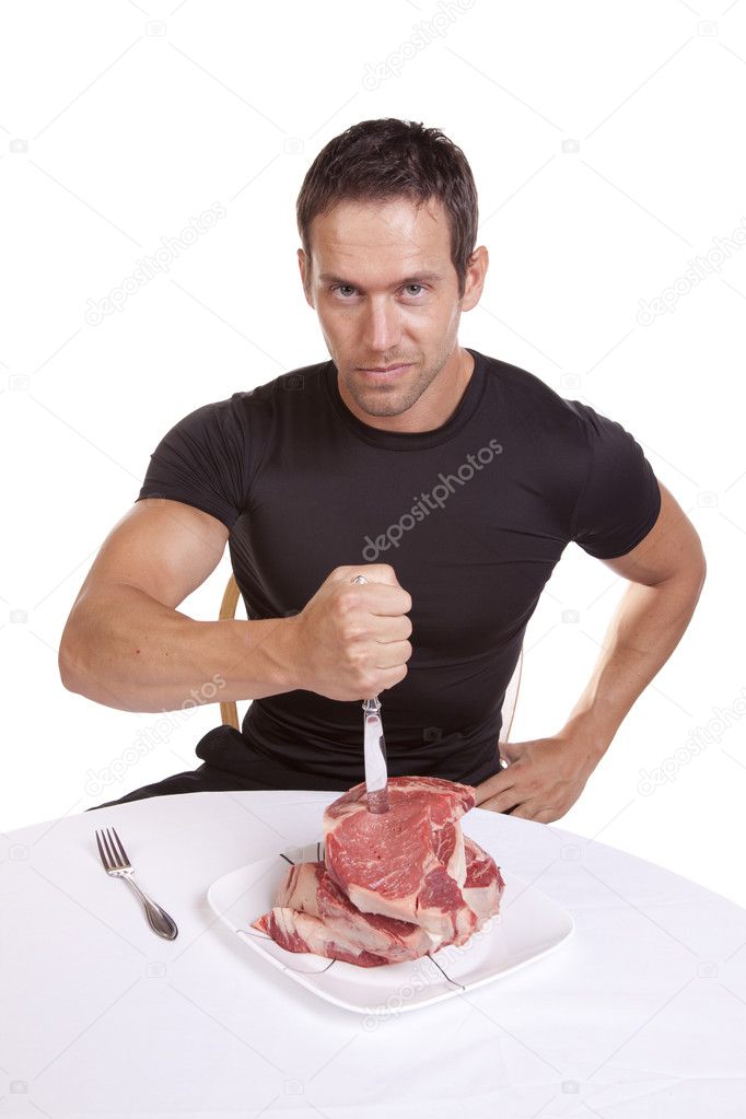Man stabbing steaks
