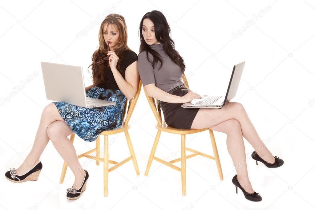 Two women laptops peeking