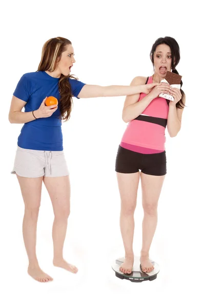 Two women scales chocolate — Stock Photo, Image