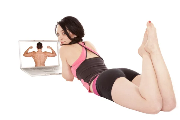 Woman laying by computer looking back — Stock Photo, Image