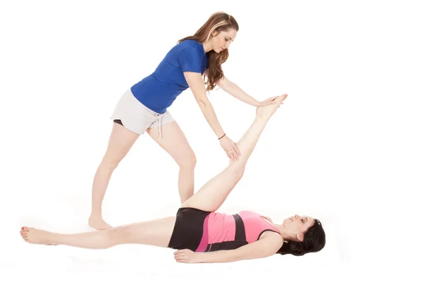 Woman stretching others leg — Stock Photo, Image