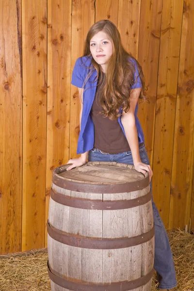 Woman by barrel serious expression — Stock Photo, Image