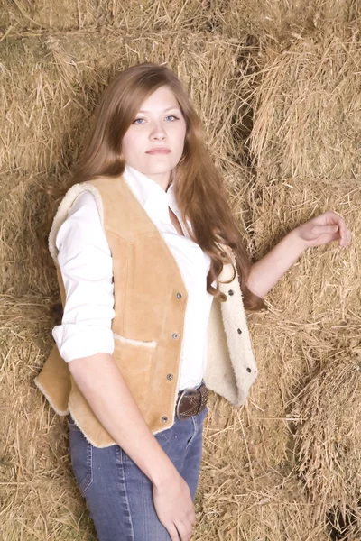 Woman by haystack serious expression — Stock Photo, Image