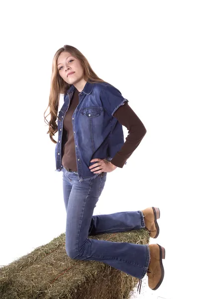 Woman kneeling on hay — Stock Photo, Image