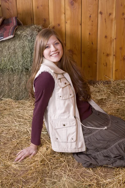 Woman smiling in hay — Stock Photo, Image