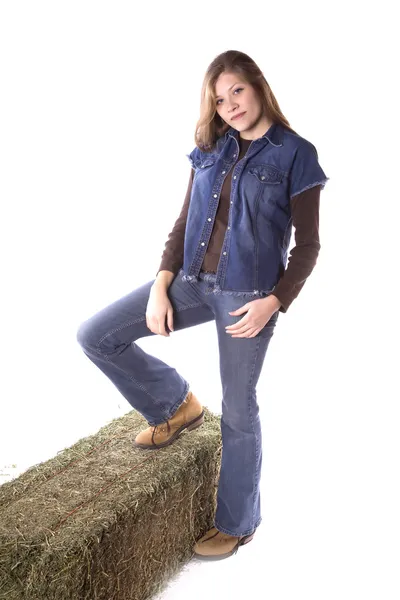 Woman standing one foot on hay — Stock Photo, Image