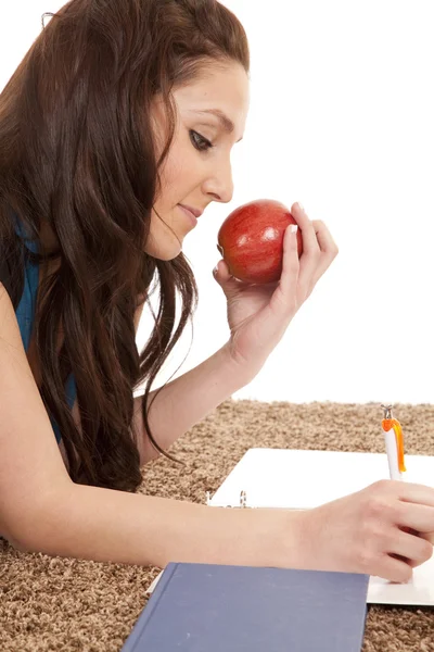 Woman on floor with apple writing — Stock Photo, Image