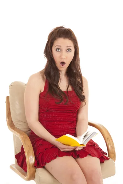 Woman red dress book sit shocked looking — Stock Photo, Image