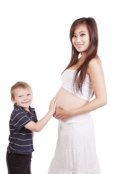 Menino tocando mães barriga olhando — Fotografia de Stock