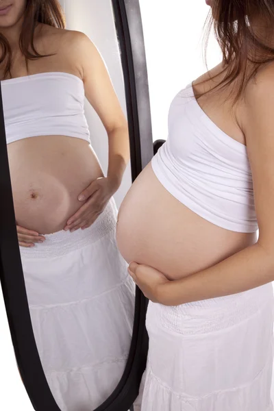 Pregnant white holding belly mirror — Stock Photo, Image