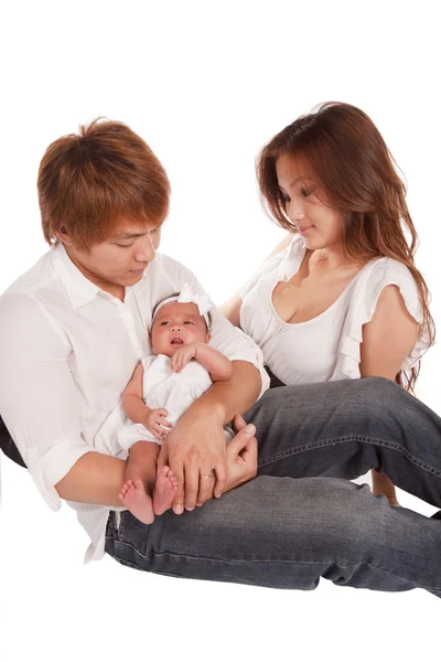 Beautiful father and mother holding their baby girl. — Stock Photo, Image