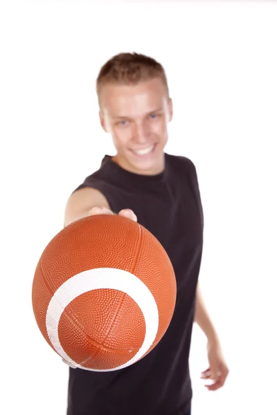 Young man handing football — Stock Photo, Image