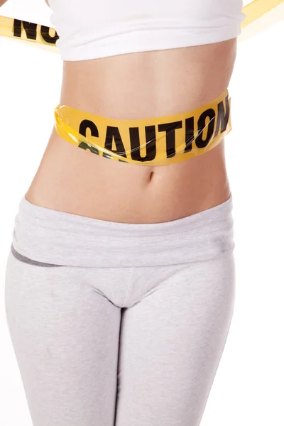 Caution tape on belly — Stock Photo, Image