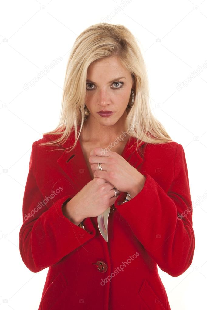 Woman red coat hold knife by chest looking
