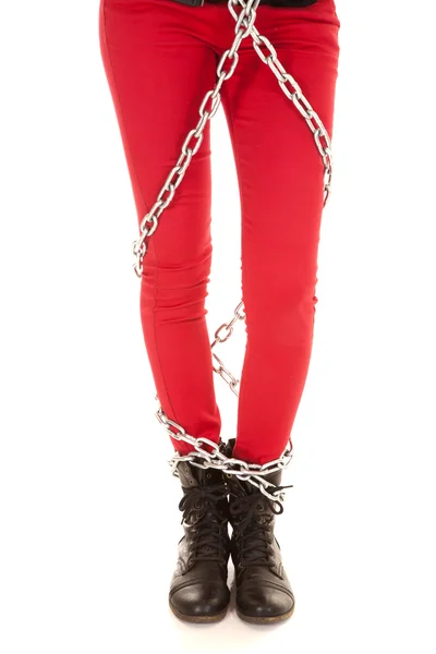 Woman legs in red pants wrapped in chains — Stock Photo, Image